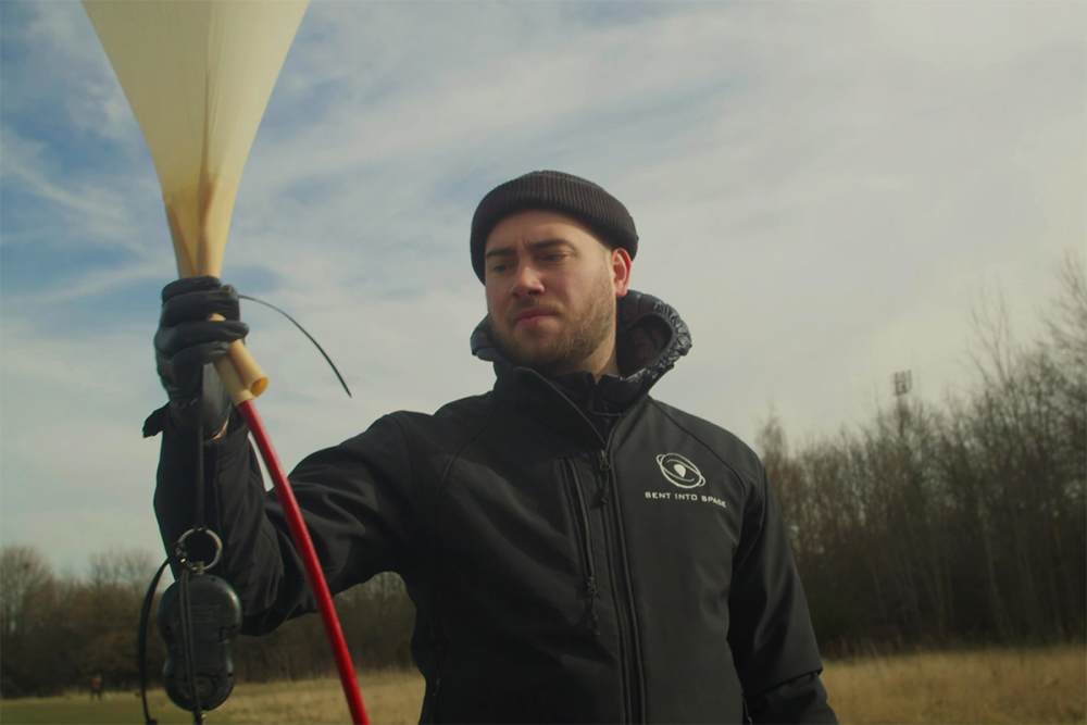 A man holding the space balloon.