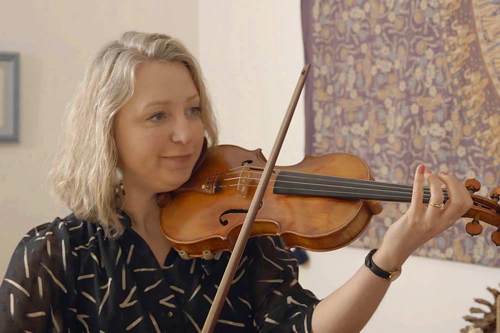 A woman playing a violin.