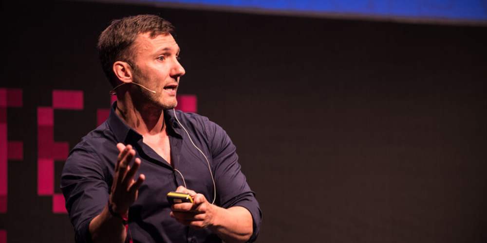 Photo of Roan Lavery on stage giving a talk at Turning Fest.