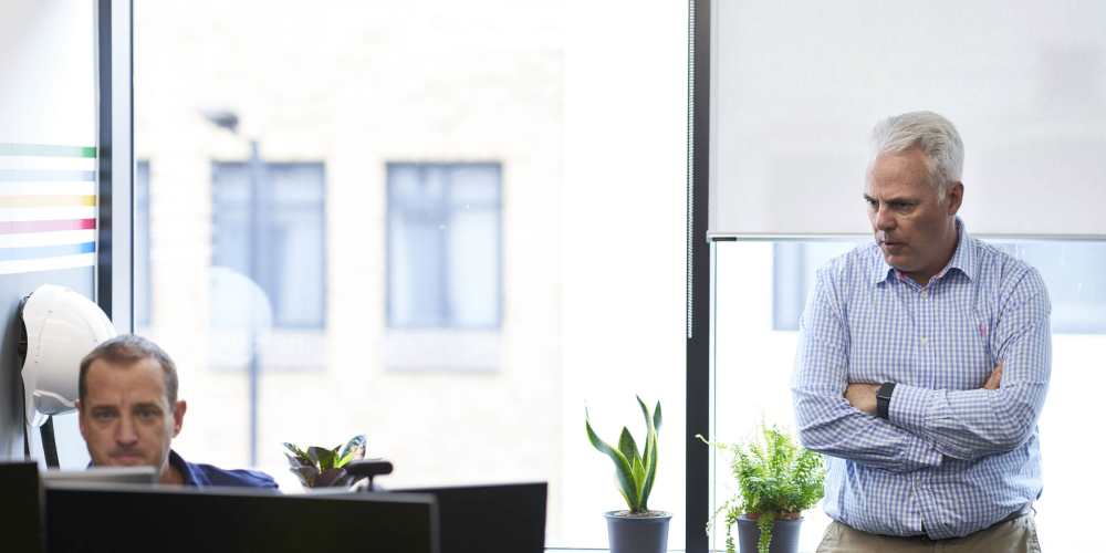 Photo of Clive Steed and Scott Goodwin looking at a computer screen.