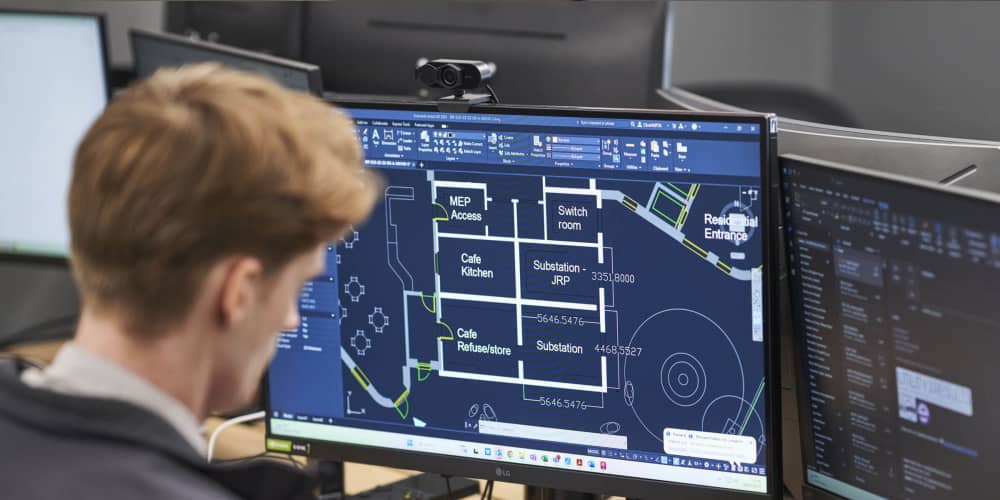 Photo of a young man looking at a computer screen.