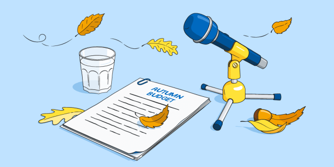 Orange autumn leaves blowing across a microphone and a document titled ‘Autumn Budget’. 